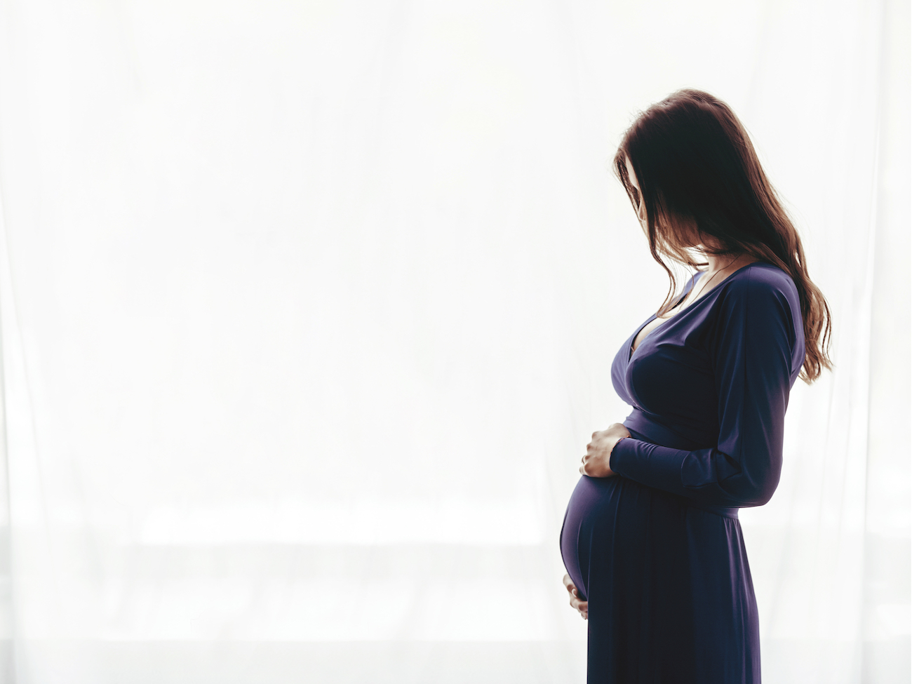 woman carrying baby from kingwood ivf with gestational surrogate 
