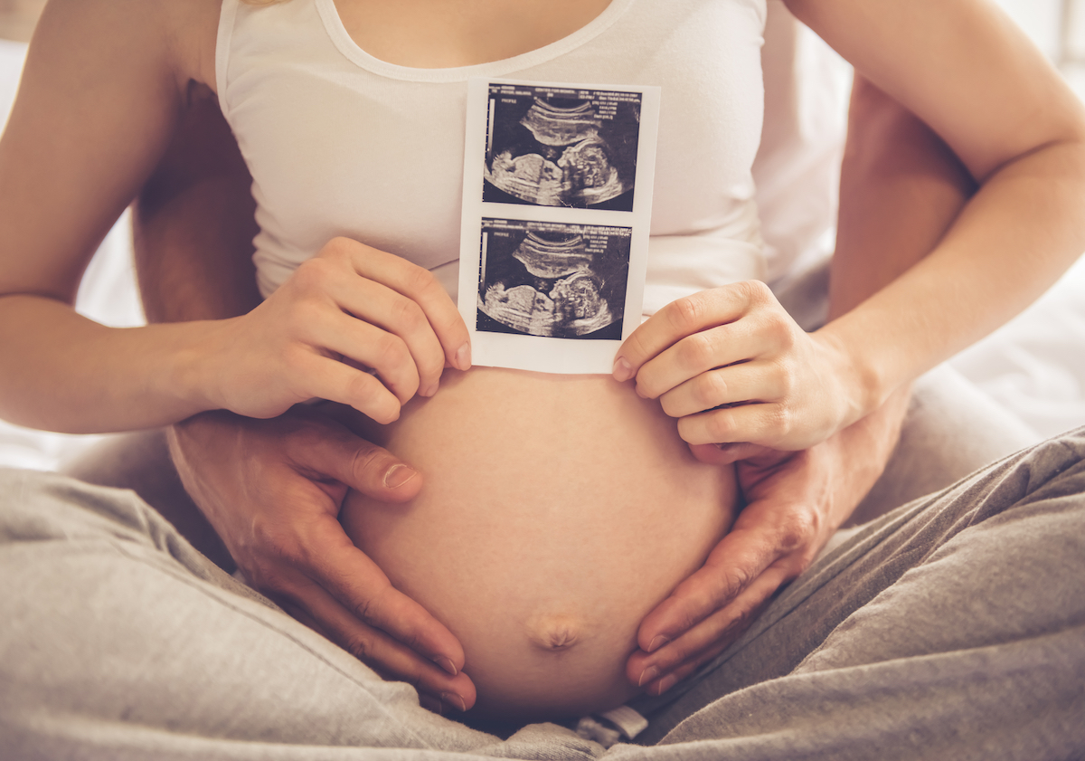 Couple with picture of ultrasound after The Woodlands IVF treatment with donor sperm