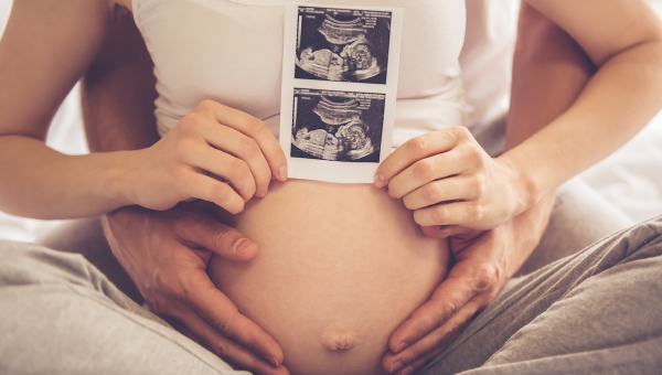 Couple with picture of ultrasound after The Woodlands IVF treatment with donor sperm