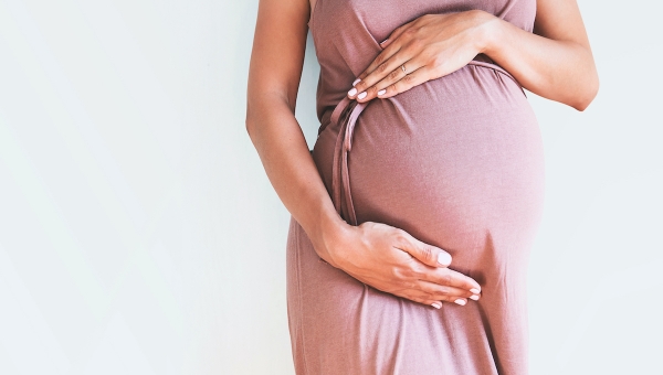 Pregnant woman holding her belly after successful IVF pregnancy