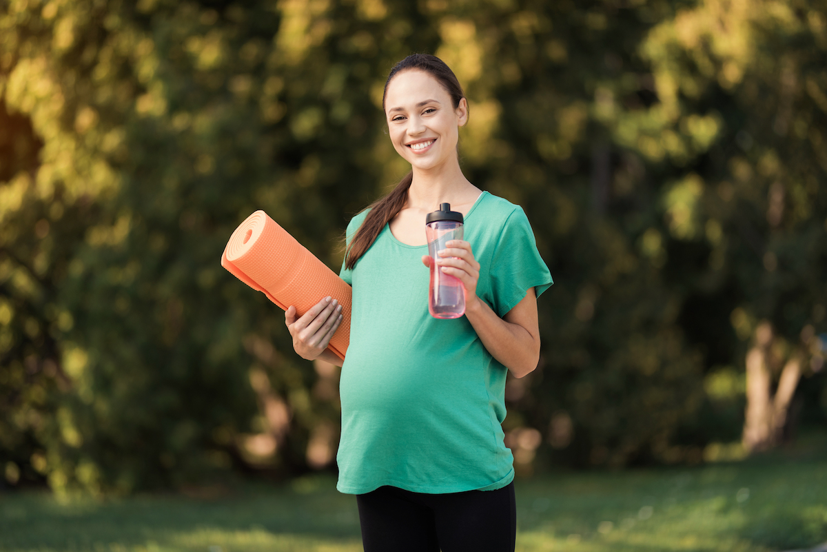 Pregnant woman exercising and living a healthy lifestyle for IVF success