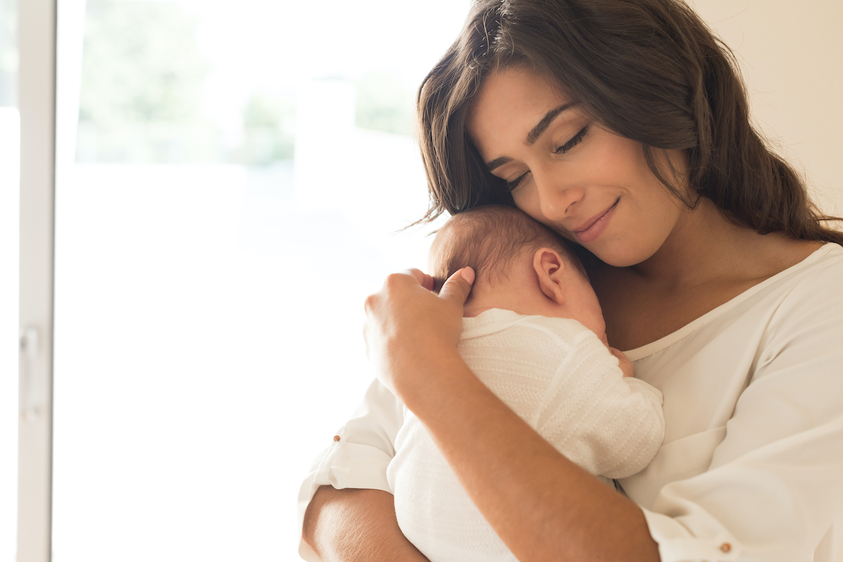 Mother holding baby after successful assisted hatching and north Houston IVF treatment