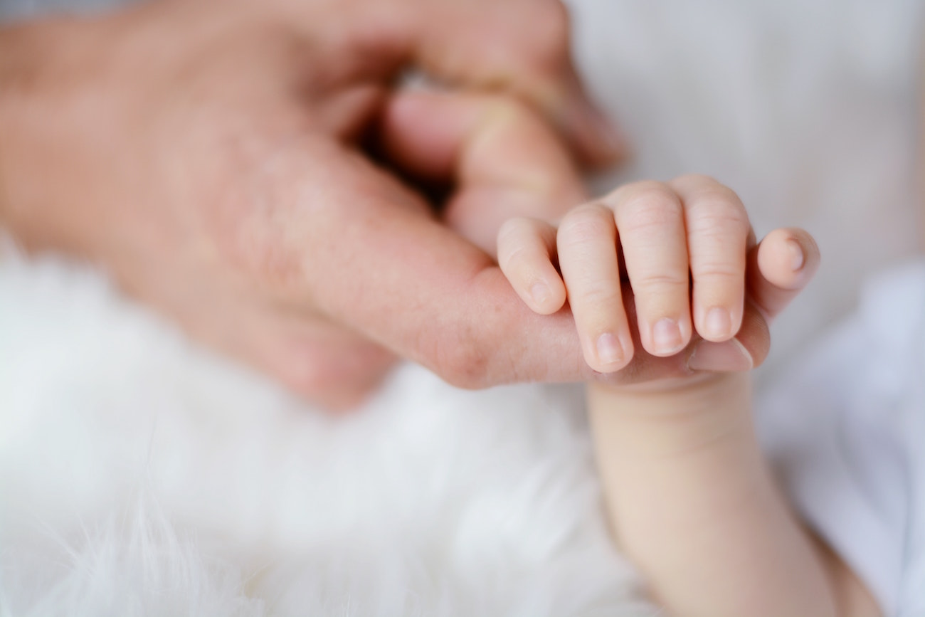 North Houston IVF baby holding parent's finger