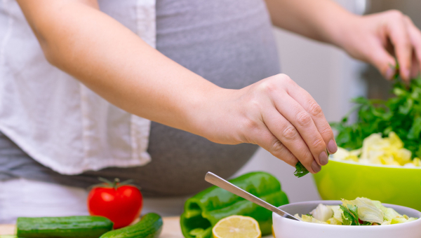 A pregnant woman eating healthy food